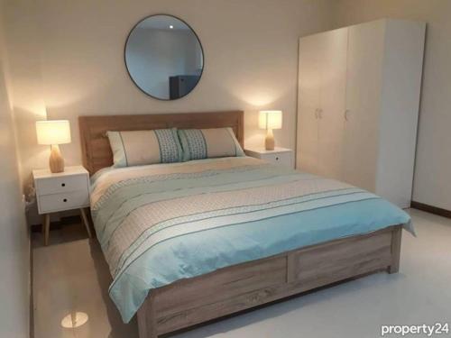 a bedroom with a large bed and a mirror at Beautiful condo in the new La Grande resort in Angeles