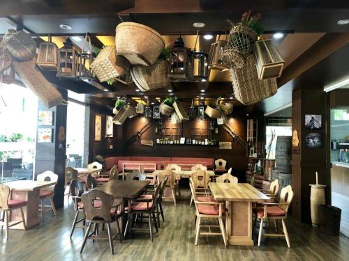a restaurant with tables and chairs and baskets on the wall at Beautiful condo in the new La Grande resort in Angeles