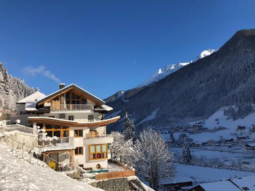 a house on top of a snow covered mountain at Hotel Garni Bergwelt in See