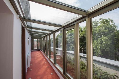 an empty room with glass doors and windows at Bükkös Hotel & Spa in Szentendre