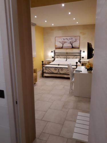 a bedroom with a bed and a table and chairs at Mediterraneo B&B in Maglie