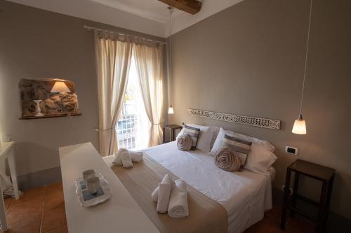 a bedroom with a white bed with towels on it at Hotel Borgo Vistalago in Trevignano Romano
