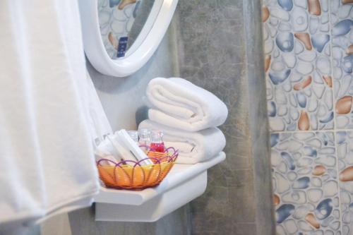 a basket of towels on a sink in a bathroom at Baan Tubkaek Hotel in Tab Kaek Beach