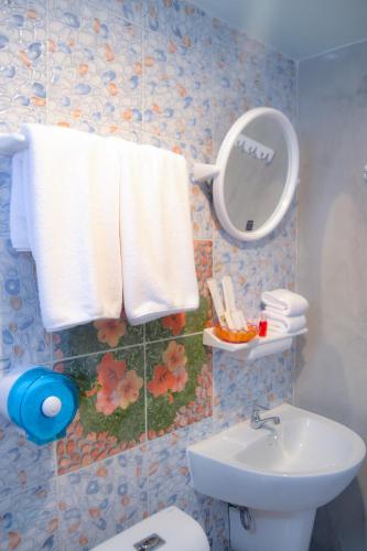 a bathroom with a toilet and a sink and a mirror at Baan Tubkaek Hotel in Tab Kaek Beach