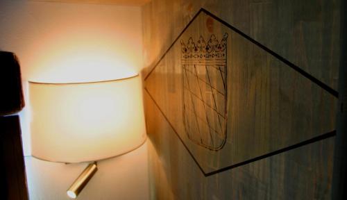 a lamp in a room with a picture on the wall at B&B Premium in Premia de Dalt
