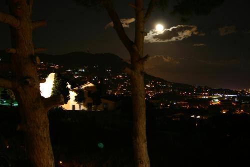 a full moon over a city at night at B&B Premium in Premia de Dalt