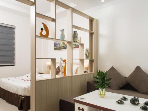 a living room with a bed and a couch at Canh Hung Palace in Hai Phong