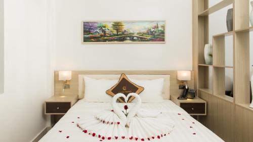 a bedroom with a bed with a heart made out of roses at Canh Hung Palace in Hai Phong