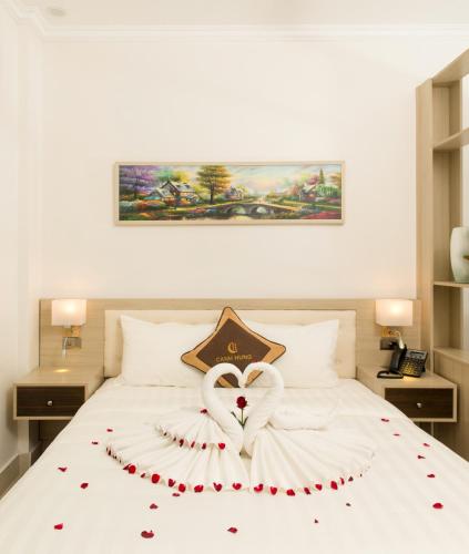 a white bed with a heart decoration on it at Canh Hung Palace in Hai Phong