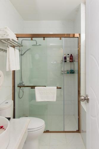 a bathroom with a glass shower with a toilet at Canh Hung Palace in Hai Phong