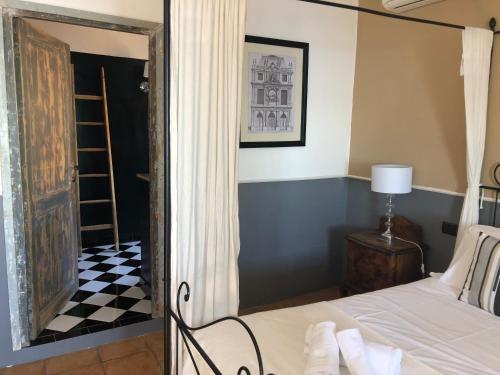 a bedroom with a bed and a black and white checkered floor at Hotel Borgo Vistalago in Trevignano Romano