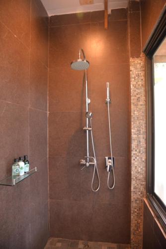 a bathroom with a shower with a shower head at Tukonnee Villas Koh Yao Noi in Ko Yao Noi