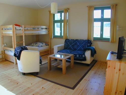 a living room with two bunk beds and a table at Ferienlandhaus Zempow in Zempow