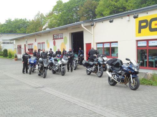 a group of motorcycles parked in front of a building at Econo Motel Goelzer in Büchenbeuren