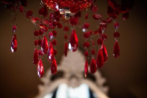 a bunch of red peppers hanging from a chandelier at Hotel Borgo Vistalago in Trevignano Romano