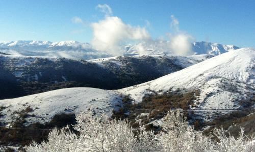 a snow covered mountain with mountains in the background at Residenza La Torre in Santo Stefano di Sessanio