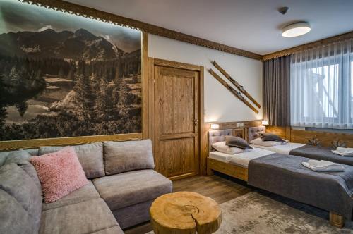 a living room with two beds and a couch at Willa Roztoka & SPA - idealne miejsce dla Twojej rodziny in Bukowina Tatrzańska
