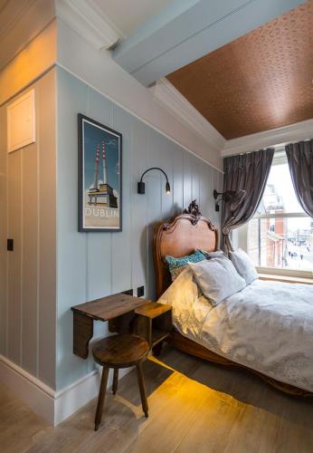 a bedroom with a bed and a table and a chair at McGettigan's Townhouse - Olives & Figs Bistro in Dublin