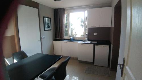 a kitchen with a table and chairs and a window at Villa Azur Cap d'Ail in Cap d'Ail