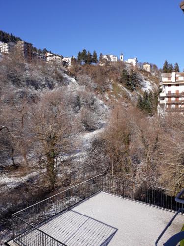 a view of a hill with trees and buildings at B&B IL GHIRO in Roccaraso