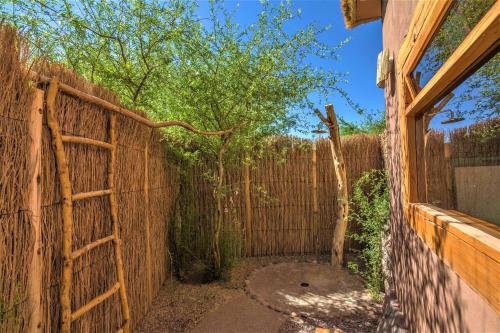 an entrance to a fence with a wooden gate at Casita La Brea in San Pedro de Atacama