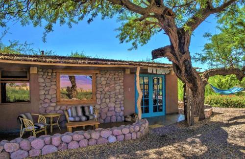 a small house with a tree in front of it at Casita La Brea in San Pedro de Atacama