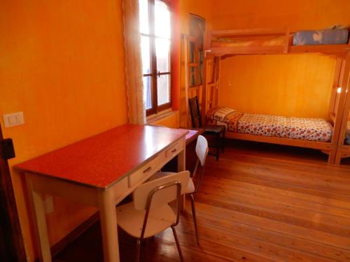 a room with a desk and a bunk bed at Il Borgo della Colomba in Fosdinovo