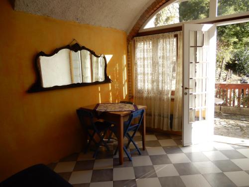 a dining room with a table and chairs and a window at Il Borgo della Colomba in Fosdinovo
