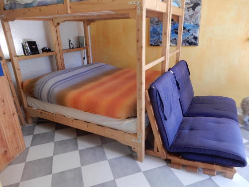 a bunk bed and a chair in a room at Il Borgo della Colomba in Fosdinovo
