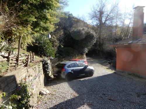 a car is parked under a tunnel in a driveway at Il Borgo della Colomba in Fosdinovo