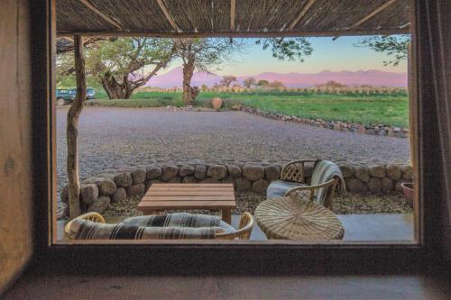 a view from a window of a table and chairs at Casita La Brea in San Pedro de Atacama