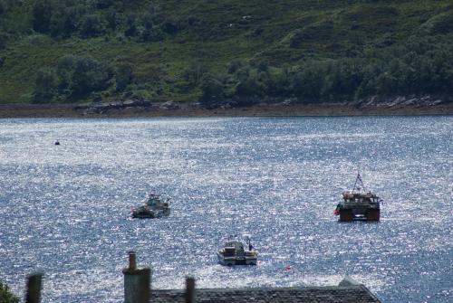 three boats in a large body of water at Skerrols in Broadford