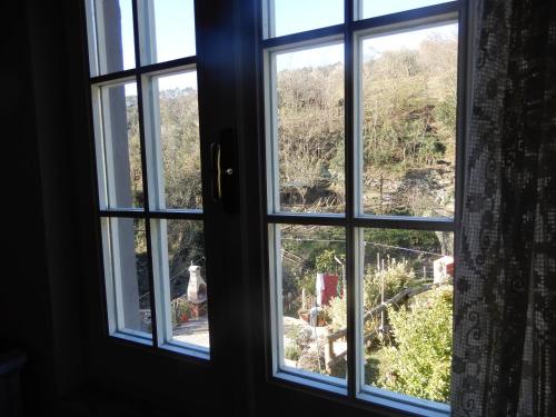 an open window with a view of a mountain at Il Borgo della Colomba in Fosdinovo