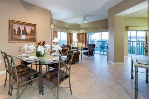 a dining room and living room with a table and chairs at WQR Private Rentals No Resort Pool Access in Orlando