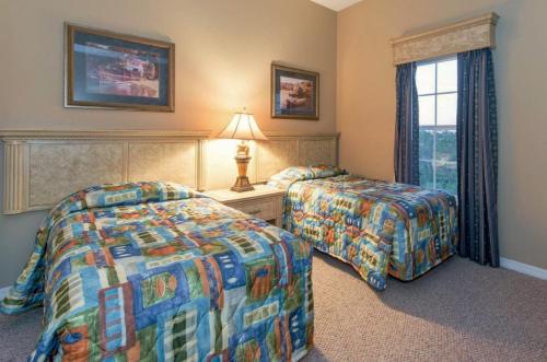 a hotel room with two beds and a window at WQR Private Rentals No Resort Pool Access in Orlando