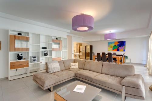 a living room with a couch and a table at Seaview Apartment In Fort Cambridge, Sliema by Buena Vista in Sliema