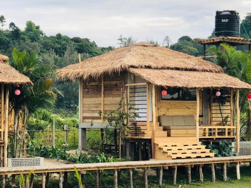 a small hut with a thatch roof at Moon Nest in Dhoāpālong