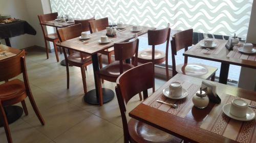 a dining room with wooden tables and chairs at Hotel Caribe in Mar del Plata