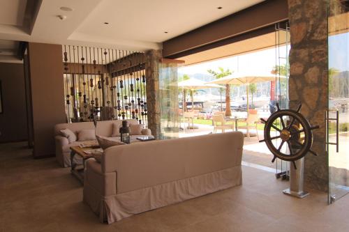 a living room with a couch and a table at Marti Hemithea Hotel in Orhaniye