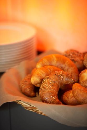 a plate of bagels and buns on a table at Victoria - Alpine Boutique Hotel & Fine Dining in Meiringen