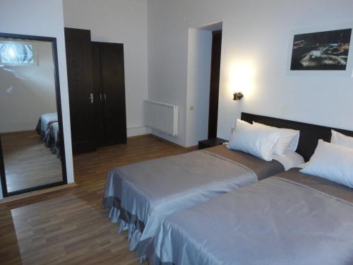 a hotel room with two beds and a mirror at Hotel Corner in Tbilisi City