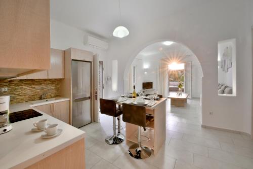 a kitchen with a island in the middle of a room at AC Village Christoulis in Mýkonos City