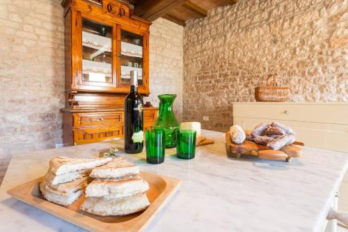 a table with bread and a bottle of wine at Villa Costanzi: Beautiful Rural Apartment! in Sigillo
