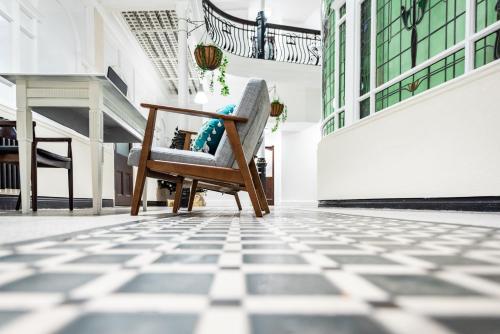 a chair in the middle of a room with a tile floor at Terlon Apartments in Liverpool