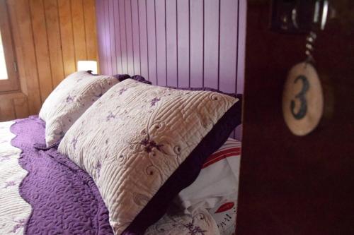 a bedroom with a bed with two pillows on it at Paraiso Patagonico in Chaitén