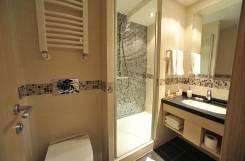 Un baño con ducha, inodoro y lavabo. en Apartmani Air, en Kopaonik