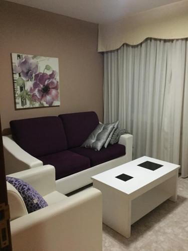 a living room with a couch and a coffee table at Pensión Quilmes in Vimianzo