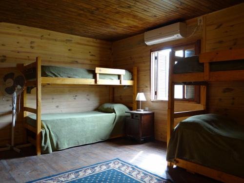 a bedroom with two bunk beds in a cabin at AMBRA in Punta Del Diablo