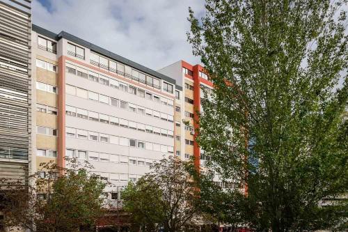 a large white building with trees in front of it at Lisboa Central Park Hotel Suites & Studios in Lisbon