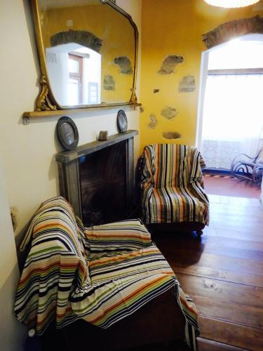 a living room with a fireplace and a mirror at Il Borgo della Colomba in Fosdinovo
